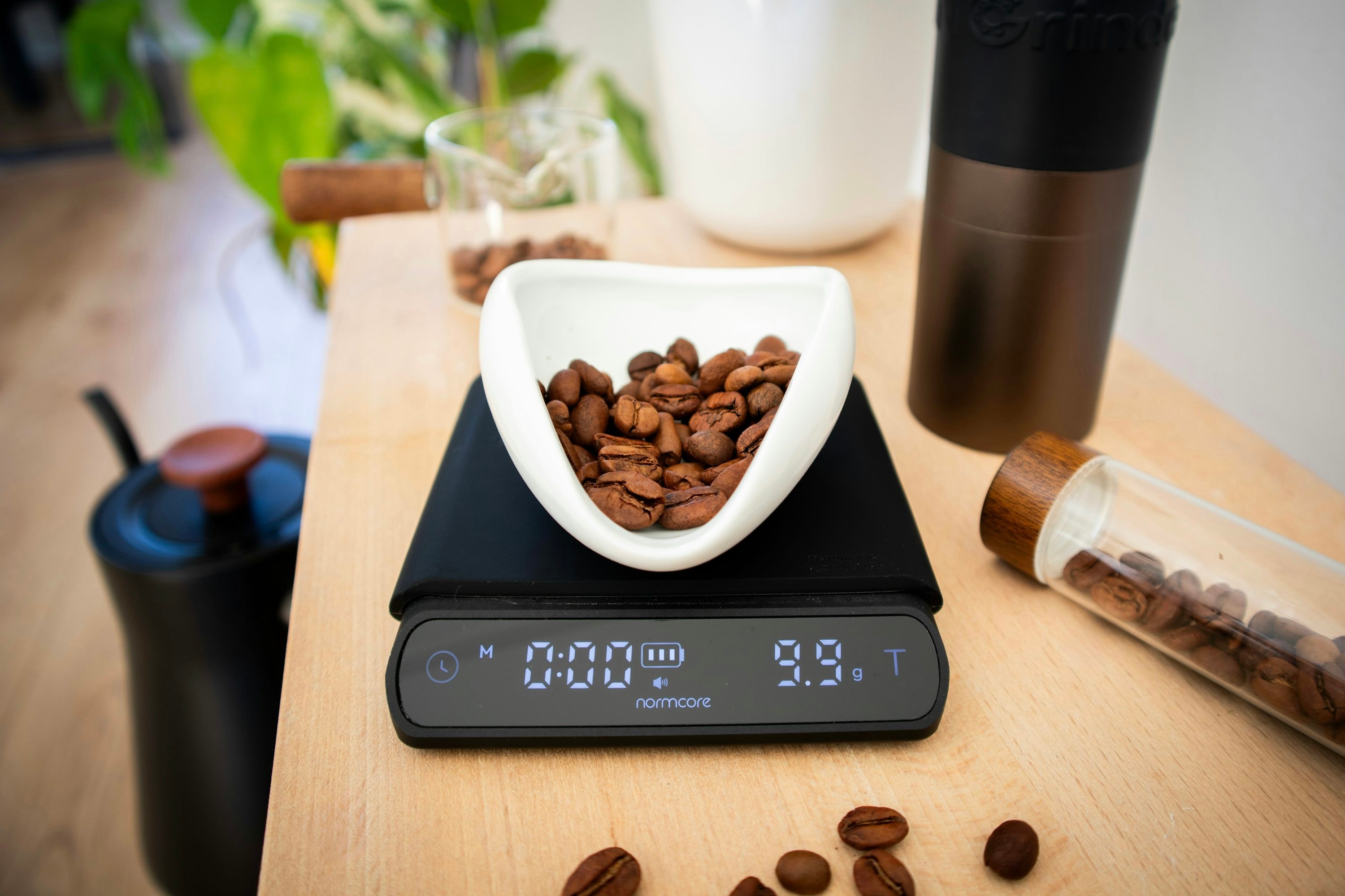 Digital coffee scale weighing freshly roasted coffee beans in a white bowl