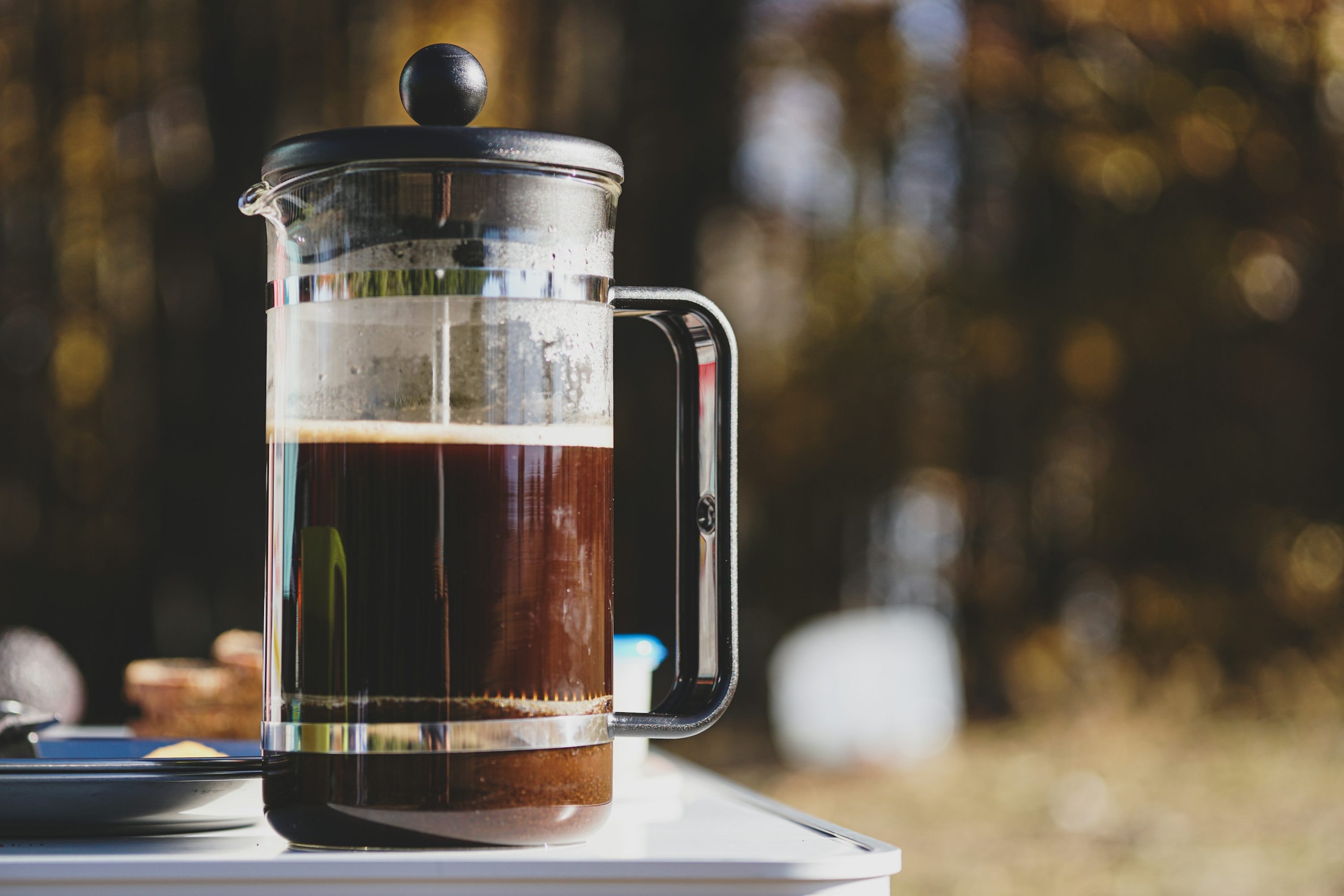 French press coffee maker on a table, morning coffee brewing setup