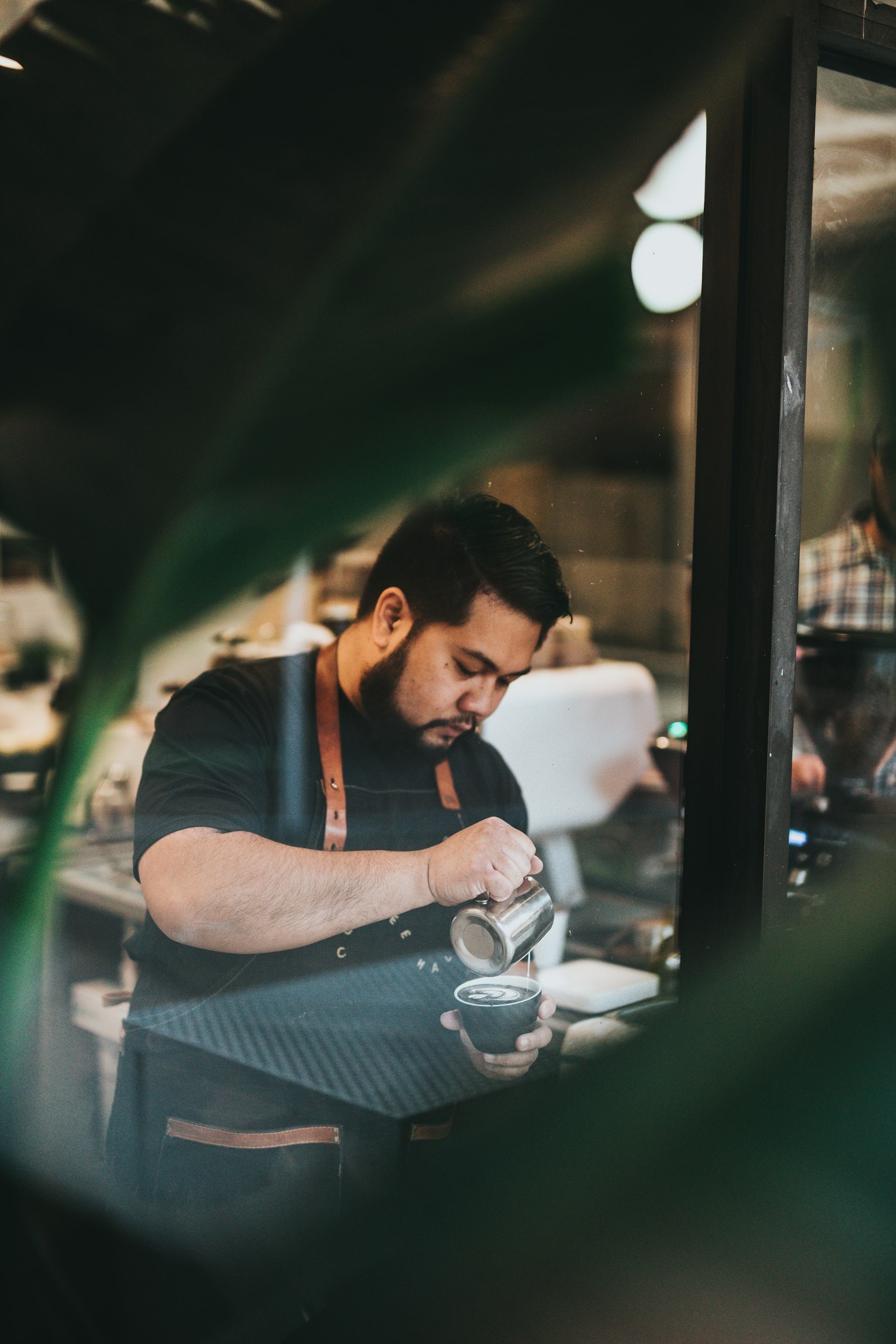 Hand pouring coffee into a cup during brewing